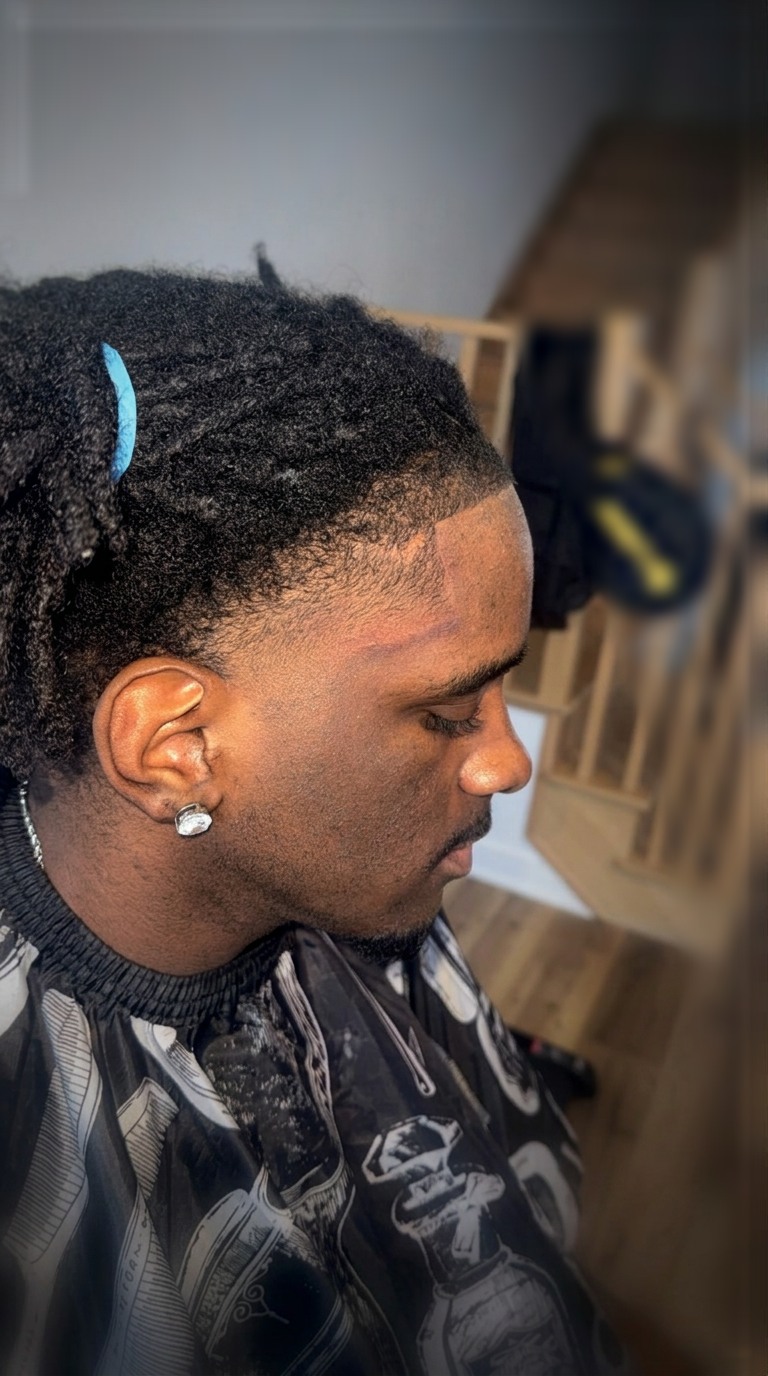 Sharp lineup with a taper fade and curly top