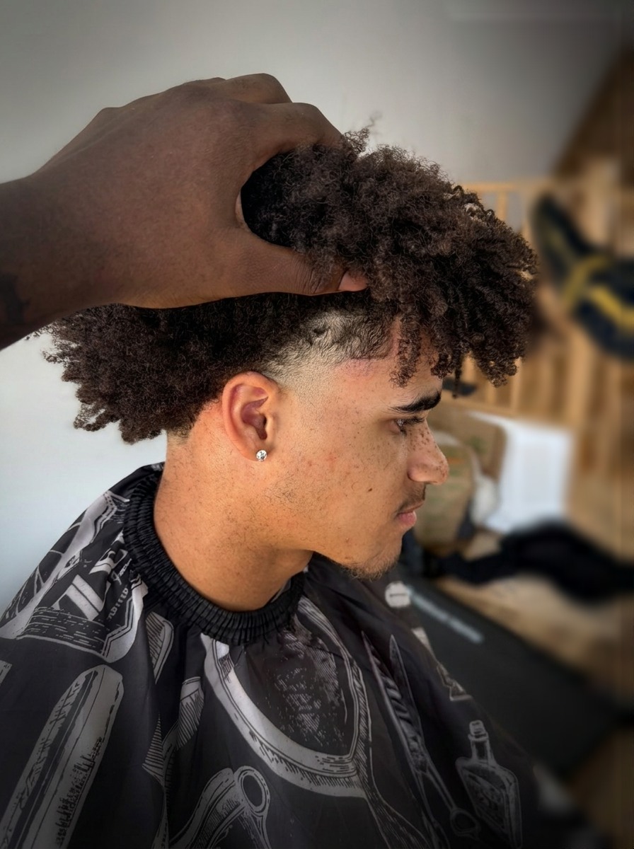 Crisp lineup with a blowout taper and curls